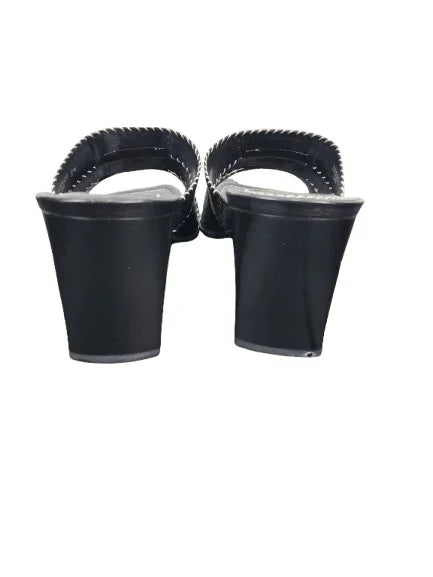 Black high-heeled shoes with open-toe design on a white background
