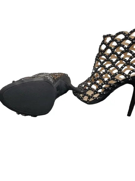 Black high-heeled shoe with a lattice design on a white background