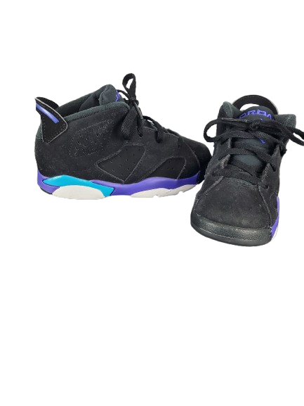 Pair of black sneakers with purple and blue accents on a white background