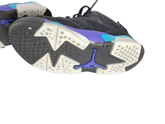 Close-up of a sneaker with a distinctive sole design on a white background