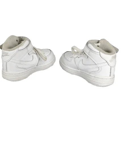 Pair of white high-top sneakers on a white background