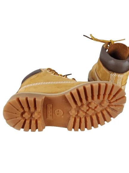 Close-up of a pair of tan boots with a focus on the sole and brand logo.