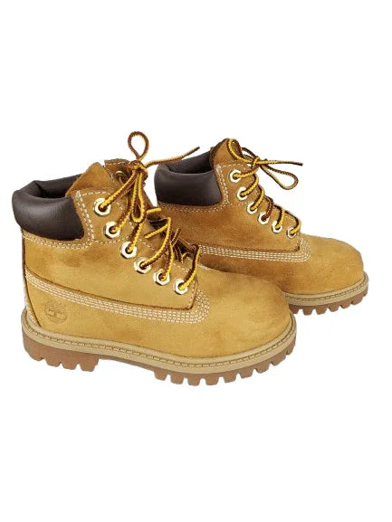 Pair of tan boots with brown accents on a white background