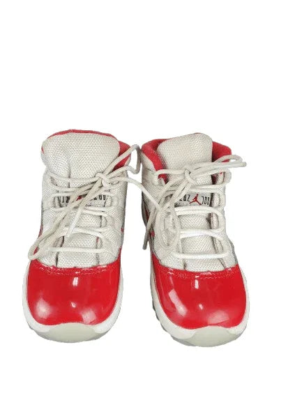 Pair of red and white sneakers on a white background