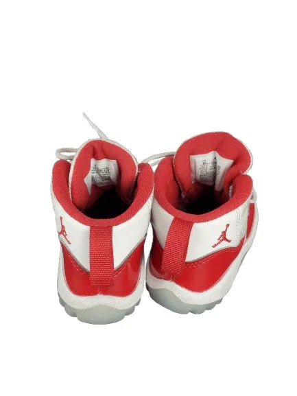 Red and white sneakers with a logo on a white background