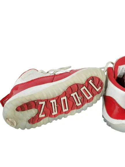 Red and white sneakers with 'Zoo York' branding on a white background