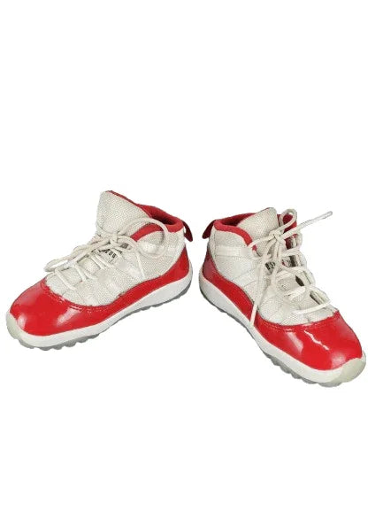 Pair of red and white sneakers on a white background