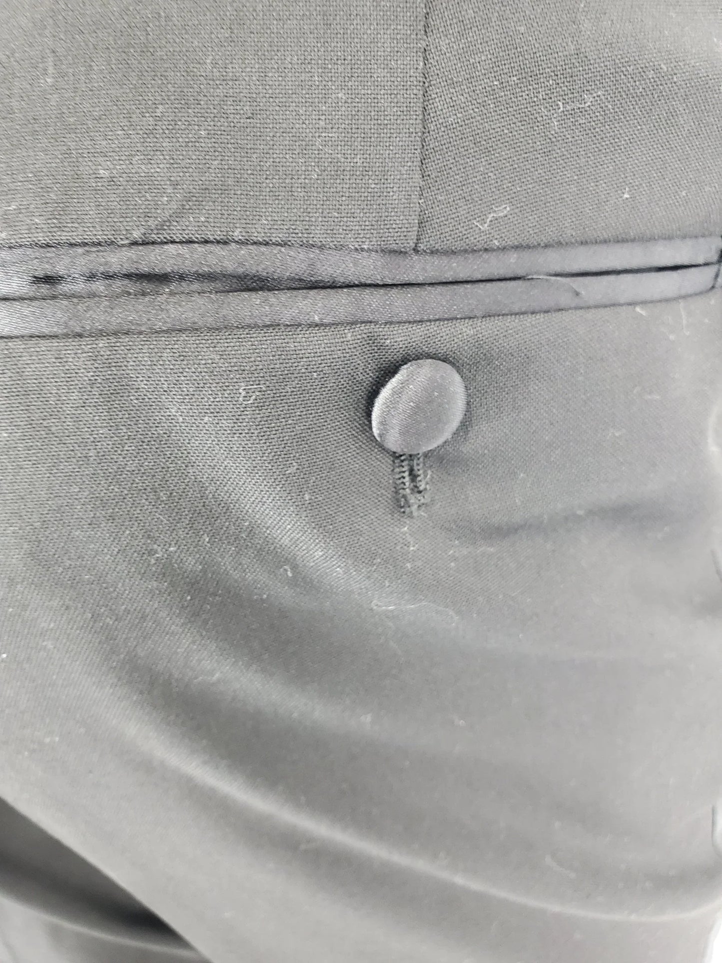 Close-up of a button on a gray fabric surface
