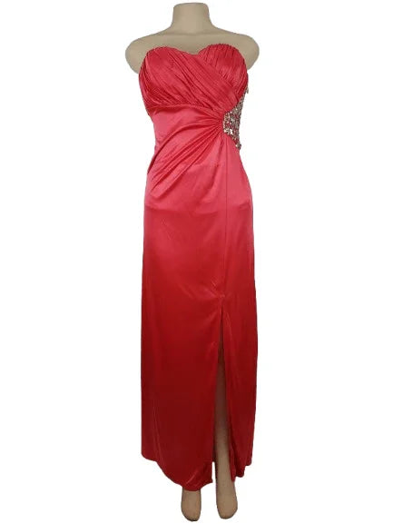 Pink strapless evening gown with beaded embellishments on a mannequin against a white background