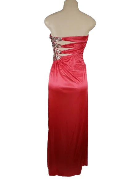 Pink evening gown with embellishments on a mannequin against a white background
