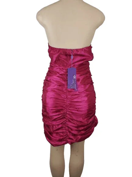 Pink strapless dress on a mannequin with a tag against a white background