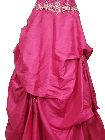 Pink gown with floral embellishments on a white background