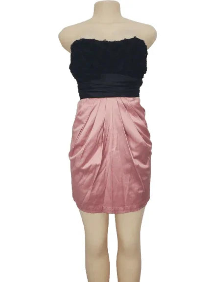 Mannequin wearing a black and pink dress on a white background