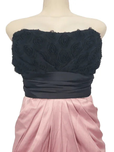 Black strapless dress with floral details on a mannequin against a white background