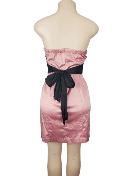 Pink strapless dress with a black belt on a mannequin against a white background