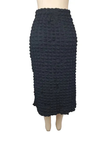 Black textured skirt on a mannequin against a white background