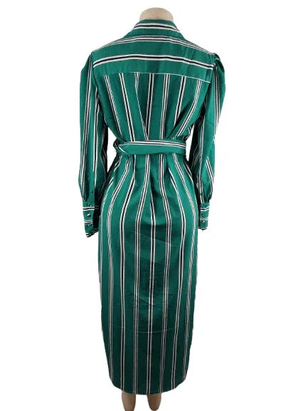 Green and white striped dress on a mannequin against a white background