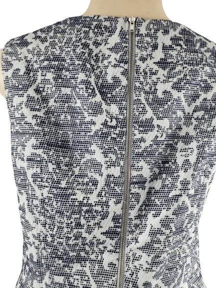 Sleeveless top with blue and white abstract pattern on a mannequin