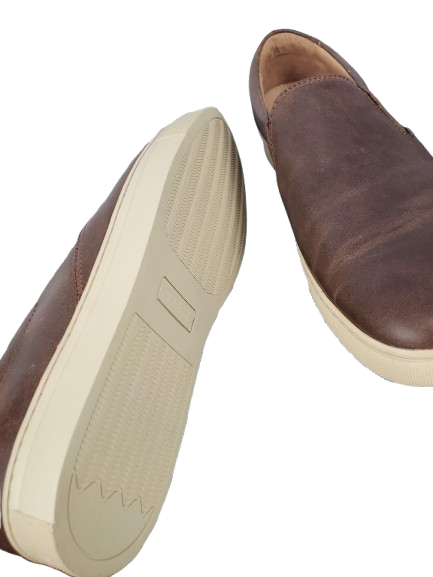 Brown leather shoes with beige soles on a white background