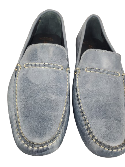 Pair of light blue loafers on a white background