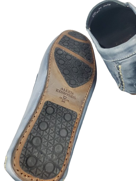 Close-up of a shoe sole with 'Allen Edmonds' branding on a white background