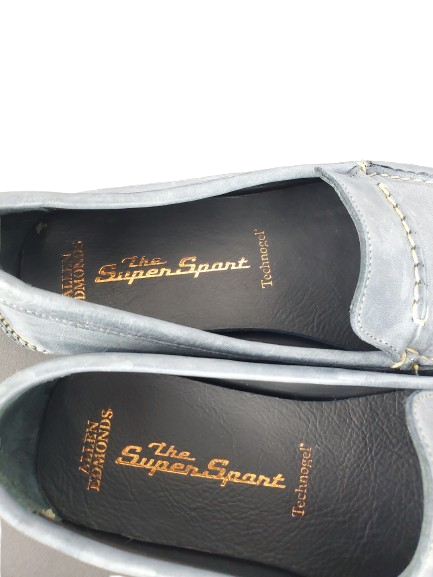 Pair of gray loafers with 'The Super Sport' branding on a white background