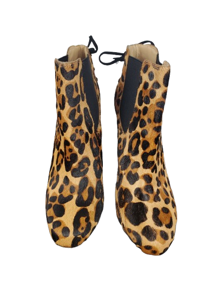 Pair of leopard print shoes on a white background