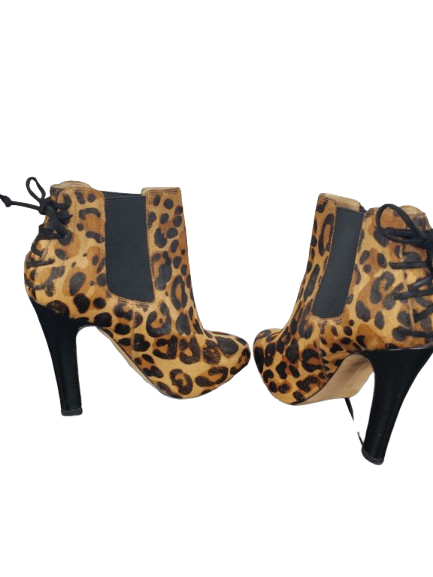 Pair of leopard print high-heeled boots on a white background