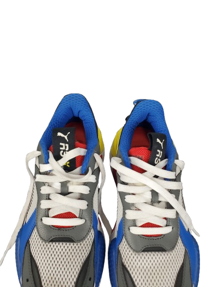 Pair of blue, gray, and red sneakers with white laces on a white background