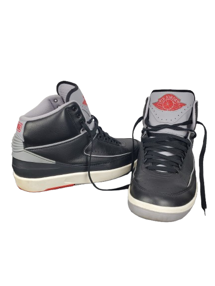 Pair of black high-top sneakers with gray and red accents on a white background