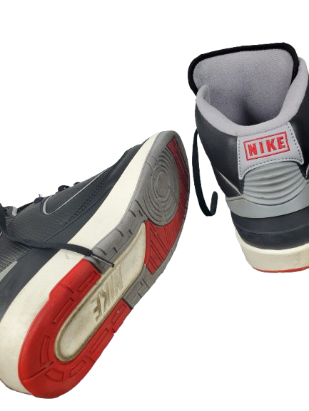 Gray and red Nike sneakers on a white background