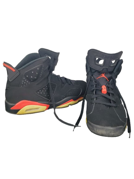 Black and red sneakers with a brand logo on a white background