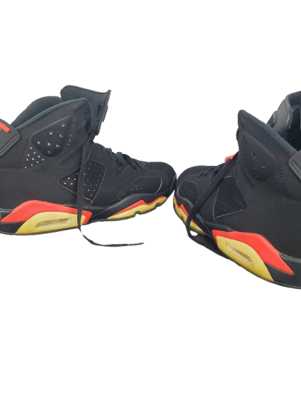 Black sneakers with red and yellow accents on a white background