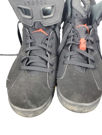 Pair of gray high-top sneakers with orange accents on a white background