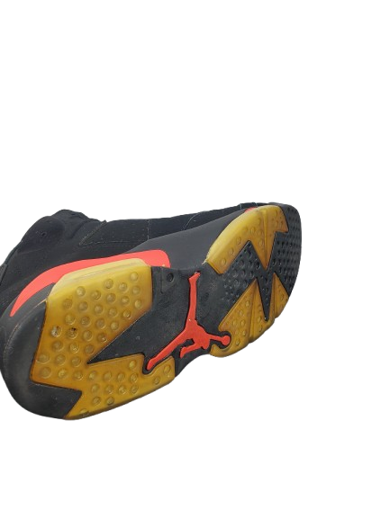 Black, yellow, and red athletic shoe sole on a white background