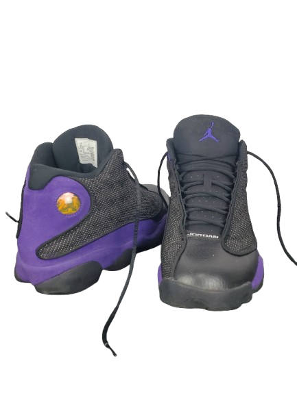 Pair of black and purple sneakers with a visible brand logo on a white background