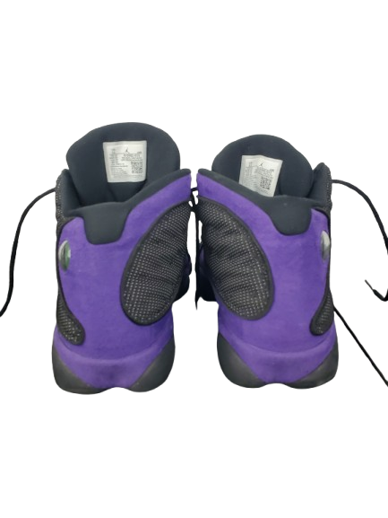 Pair of purple and black gymshoes on a white background