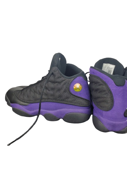 Pair of black and purple sneakers on a white background