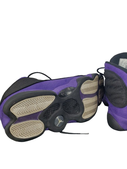 Purple and black sneaker sole on a white background