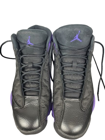 Pair of black high-top sneakers with a purple logo on a white background