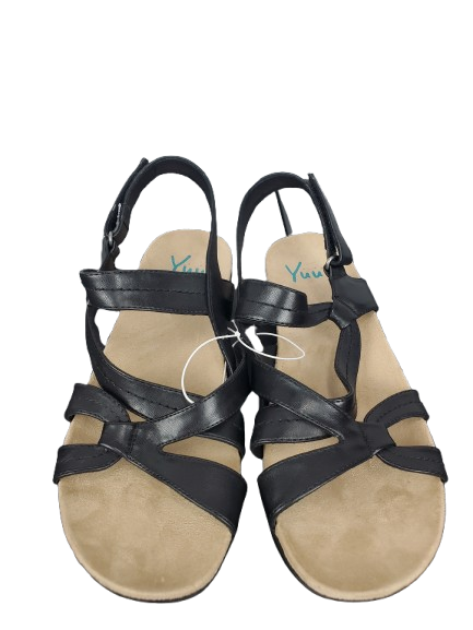 Pair of black strappy sandals on a white background
