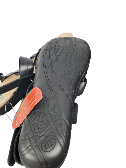 Black sandal with a textured sole on a white background