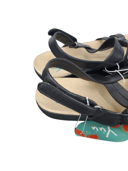 Black sandals with a visible brand tag on a white background