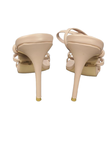 Beige high-heeled shoes on a white background