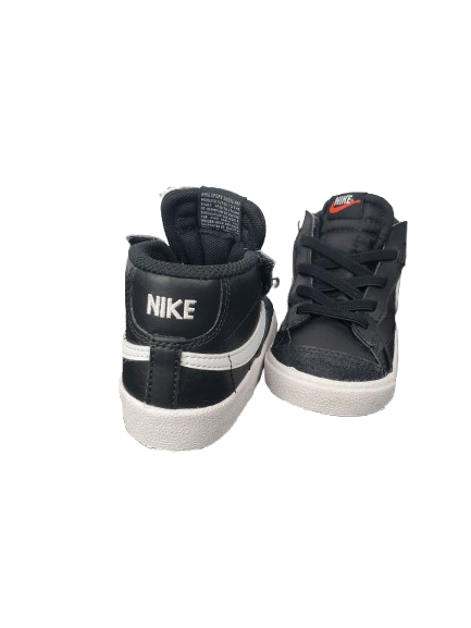 Black Nike sneakers with white soles on a white background