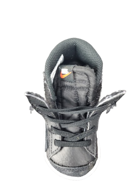 Gray sneaker with orange logo on a white background