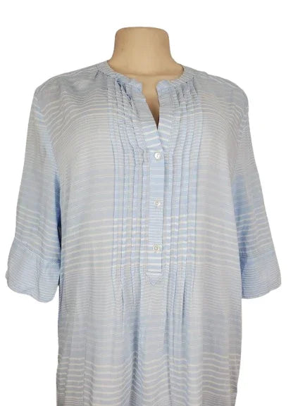 Light blue checkered shirt on a mannequin against a white background