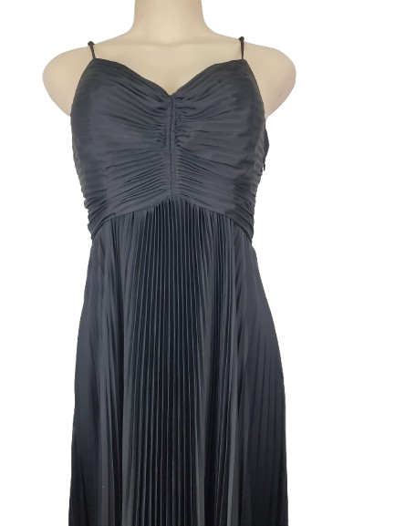 Black evening gown on a mannequin against a white background