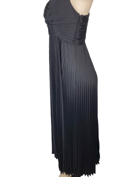 Black pleated dress on a mannequin against a white background