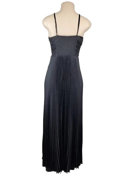 Black pleated dress on a mannequin against a white background